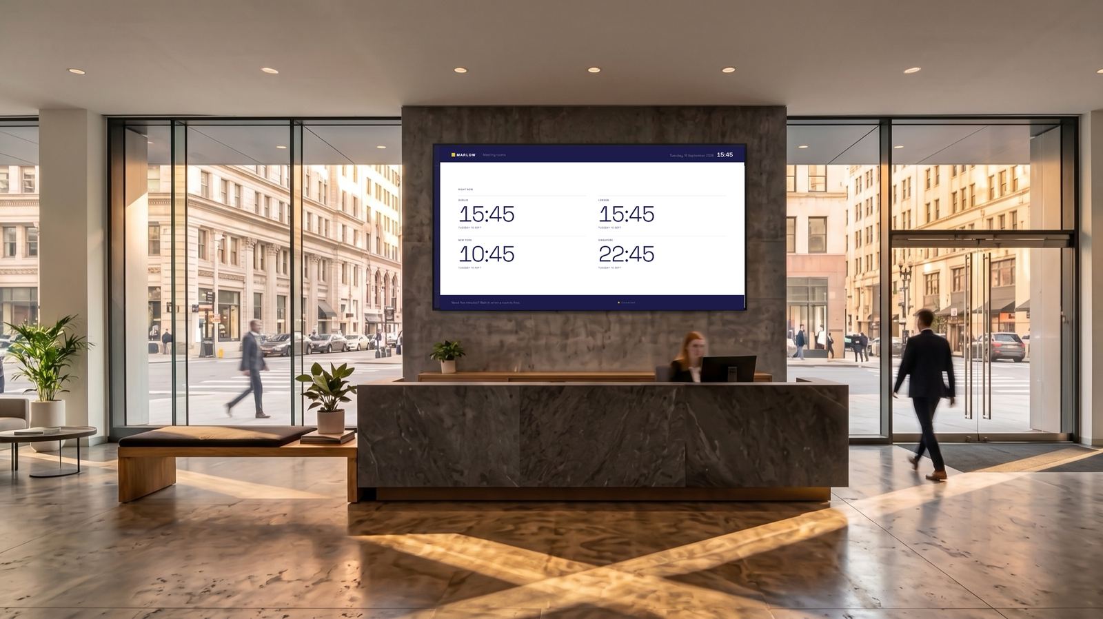 A city reception with Marlow's indigo board above the desk, showing the time in four cities